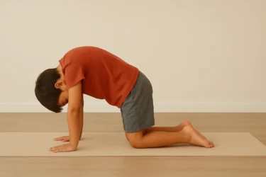 a kid doing cat stretch pose marijariasana