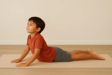 a kid doing cobra pose bhujangasana 