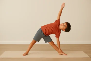 a kid doing triangle pose trikonasana