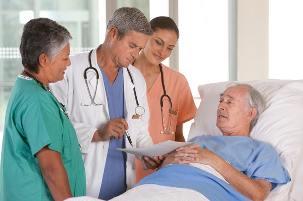 doctors speaking to a patient in bed